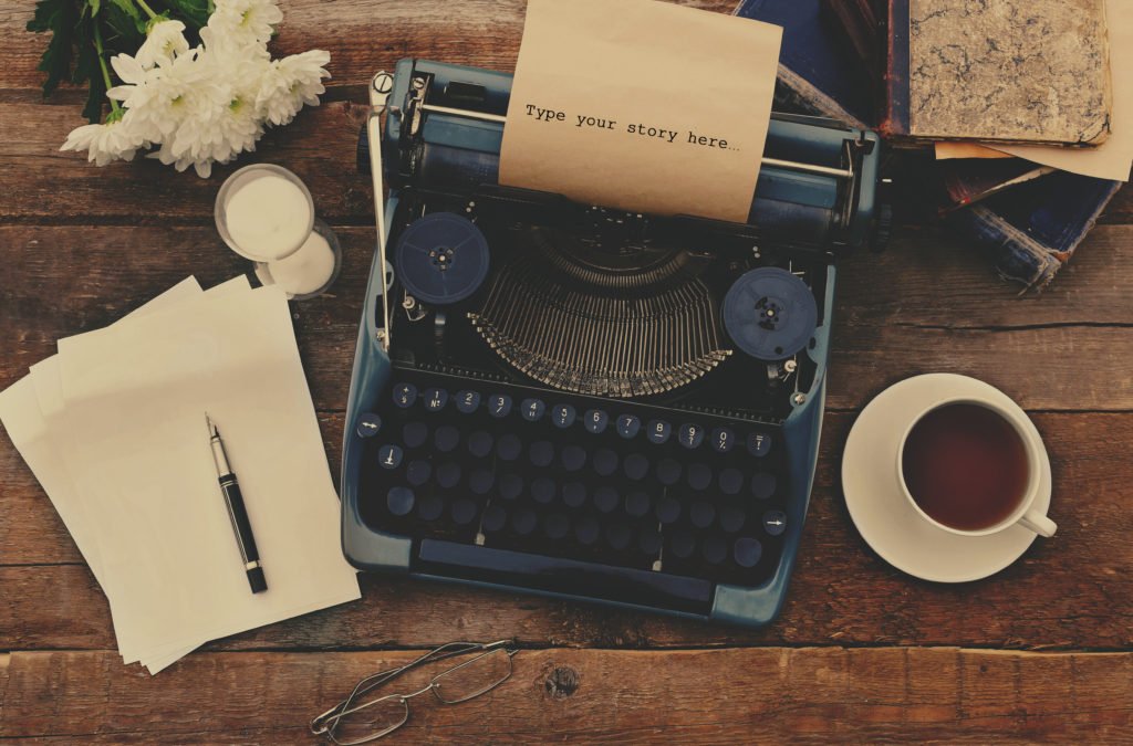 Vintage black typewriter on decorated wooden table